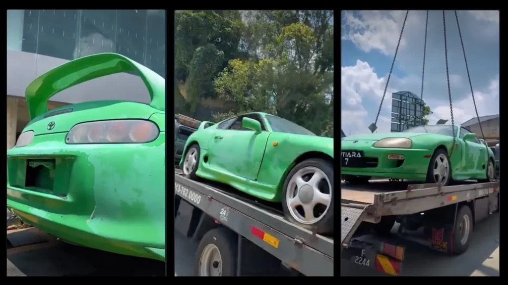 Toyota Supra MK4 verte à la peinture délavée chargée sur une dépanneuse, avec gros plan sur l'aileron arrière